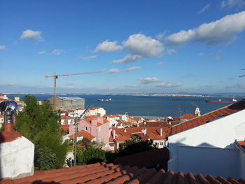 Townscape by sea against sky