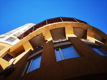 Low angle view of building against clear blue sky