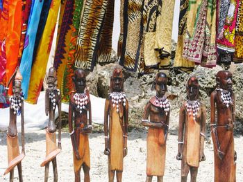 Row of multi colored decorations hanging at market stall