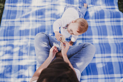 High angle view of mother and baby on bed at home