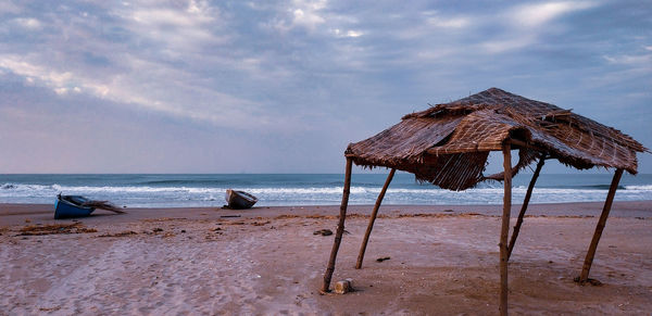 Lifeguard hut on beach against sky