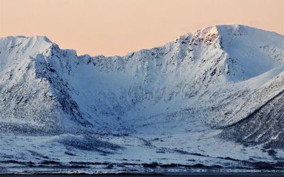 Scenic view of snowcapped mountains against clear sky