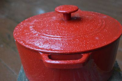 High angle view of raindrops on red metal