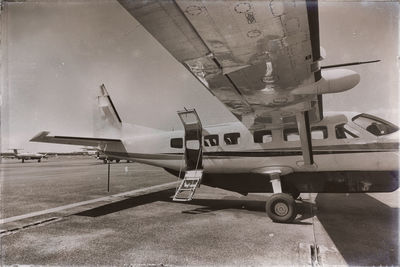 Airplane on airport runway against sky