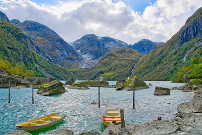 Colorful boats on the turquoise glacial water, bondhusvatnet, on a very windy day 