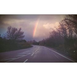 View of rainbow over road against sky