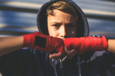 Close-up portrait of boy wearing bands on hands