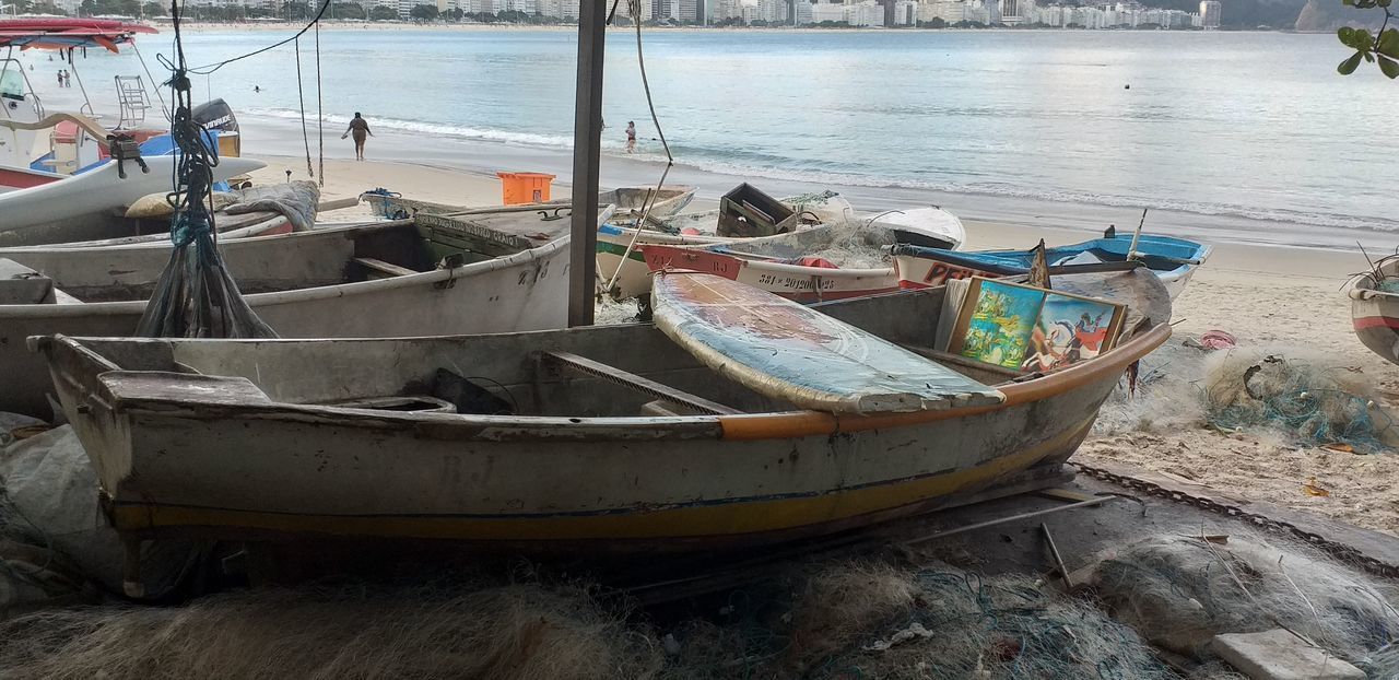 ABANDONED FISHING BOATS MOORED ON SHORE