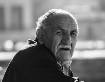 Portrait of man looking away outdoors