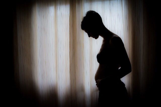 WOMAN STANDING IN THE DARK