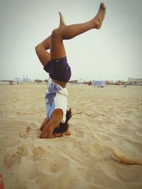 Woman jumping on beach