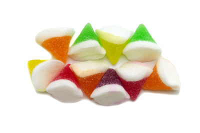 Close-up of multi colored candies against white background