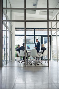 Business people discussing strategy in board room of office