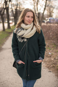 Portrait of a beautiful young woman standing in winter
