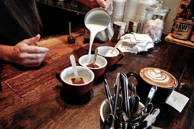 Cropped image of man having coffee at restaurant