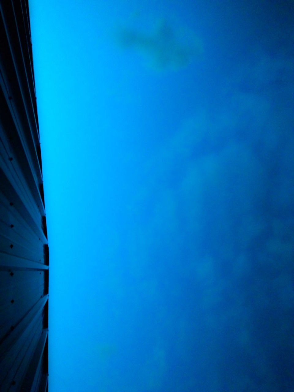 LOW ANGLE VIEW OF BUILT STRUCTURES AGAINST BLUE SKY