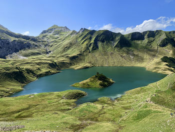 Scenic view of lake and mountains against sky