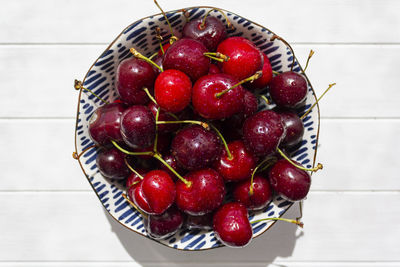 High angle view of strawberries in basket on table