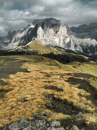 Scenic view of mountains against cloudy sky