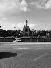 Road by city against sky