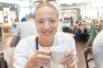 Portrait of woman drinking coffee