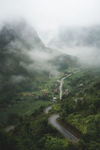 High angle view of road amidst trees against mountains