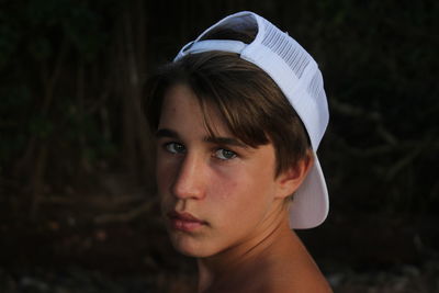 Portrait of teenage boy standing at lakeshore