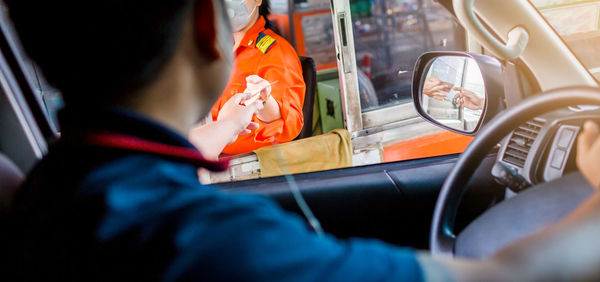 Rear view of man working in bus