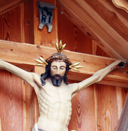 Low angle view of jesus christ sculpture on wall