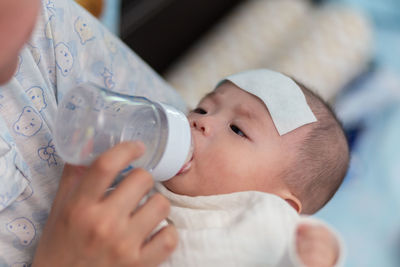 Mother feeding baby at home