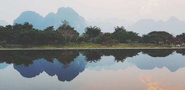 Reflection of trees in lake against sky