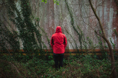 Rear view of woman walking in forest