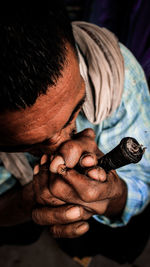 High angle view of man smoking with pipe