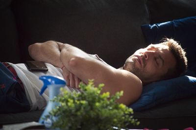 Man sleeping on sofa at home