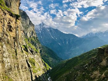 Scenic view of mountains against cloudy sky