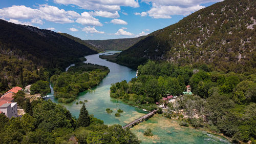 Scenic view of lake and mountains against sky
