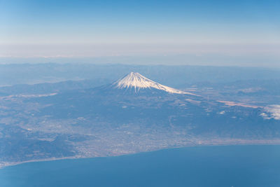 Aerial view of landscape against blue sky