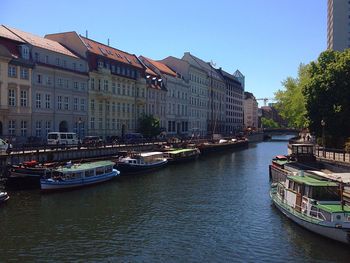 Boats in river with buildings in background