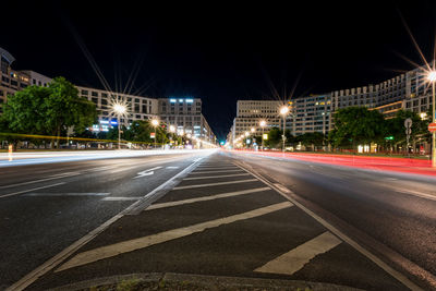 Light trails on road in city at night