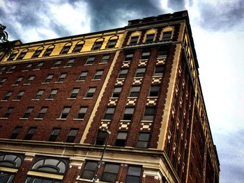 Low angle view of building against cloudy sky