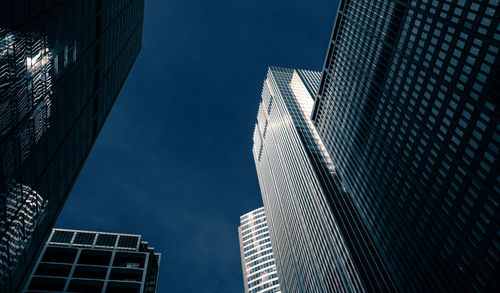 Low angle view of modern buildings against sky in city