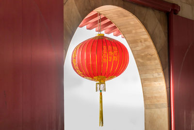 Low angle view of illuminated lanterns hanging in building