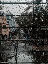 View of city street through wet glass window