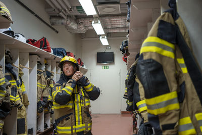 Female firefighter changing in locker