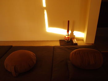 Close-up of illuminated lamp on table at home