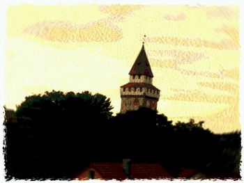 Low angle view of built structure against sky at sunset