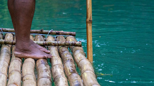 Punting down a river on a bamboo raft