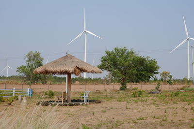 Traditional windmill on field against clear sky
