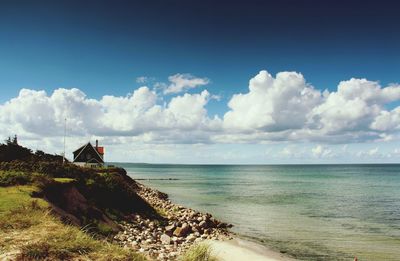 Scenic view of sea against cloudy sky