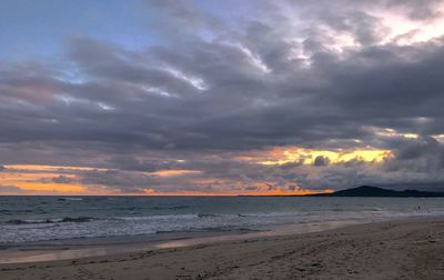 Scenic view of beach against dramatic sky